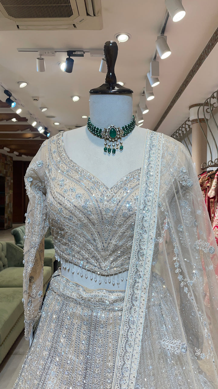 Cream net lehenga with sequins embellishments