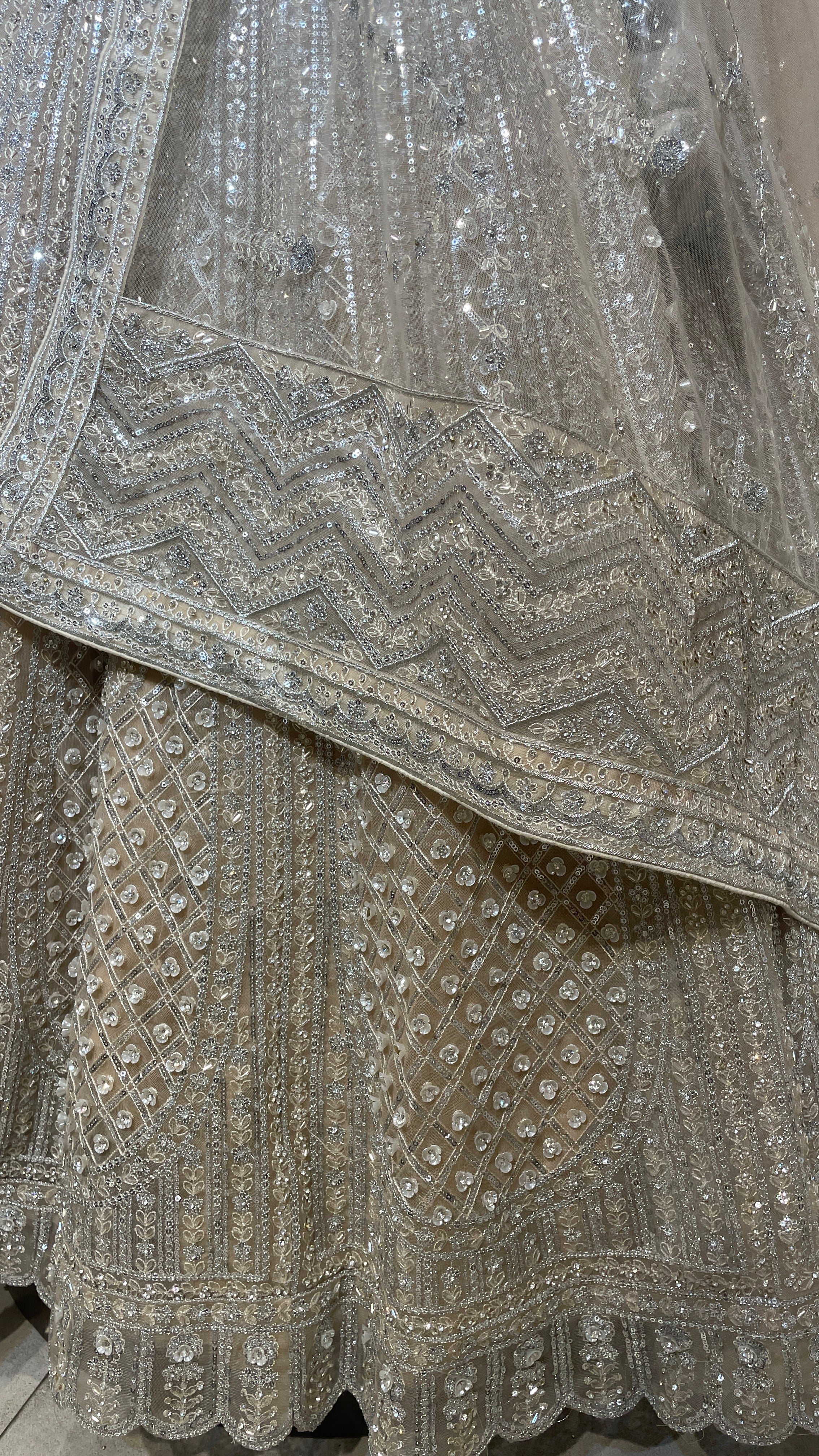 Cream net lehenga with sequins embellishments