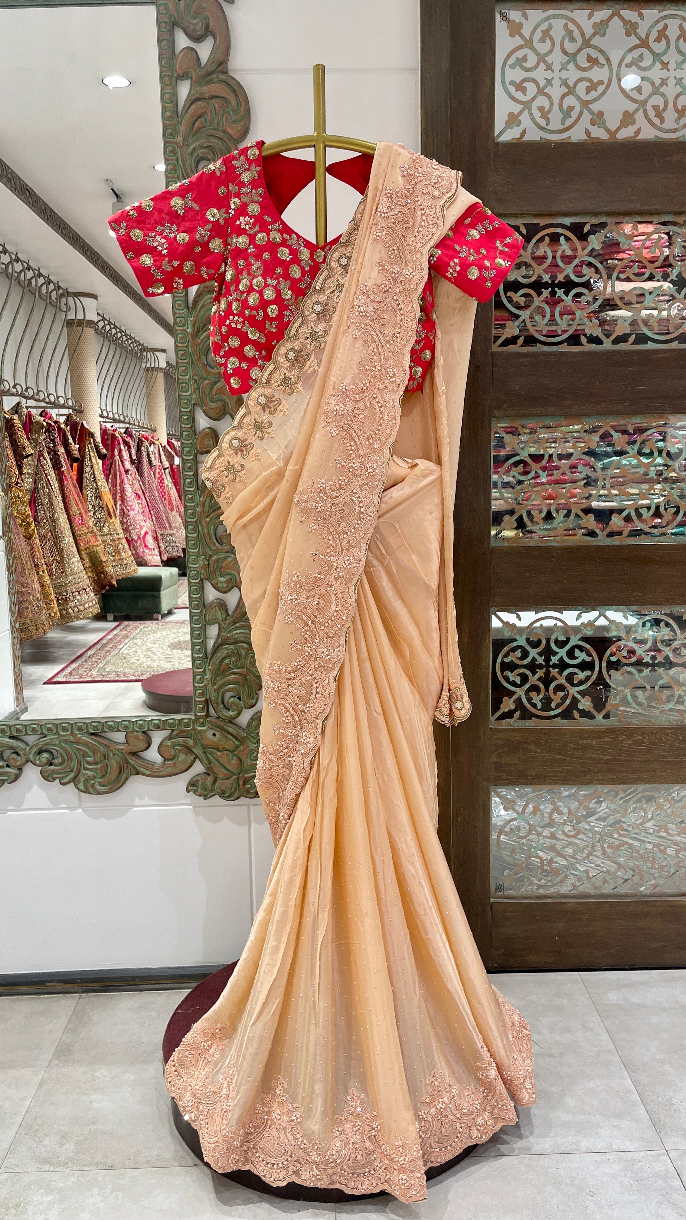 Peach Saree with Embellished Border and Red Embroidered Blouse
