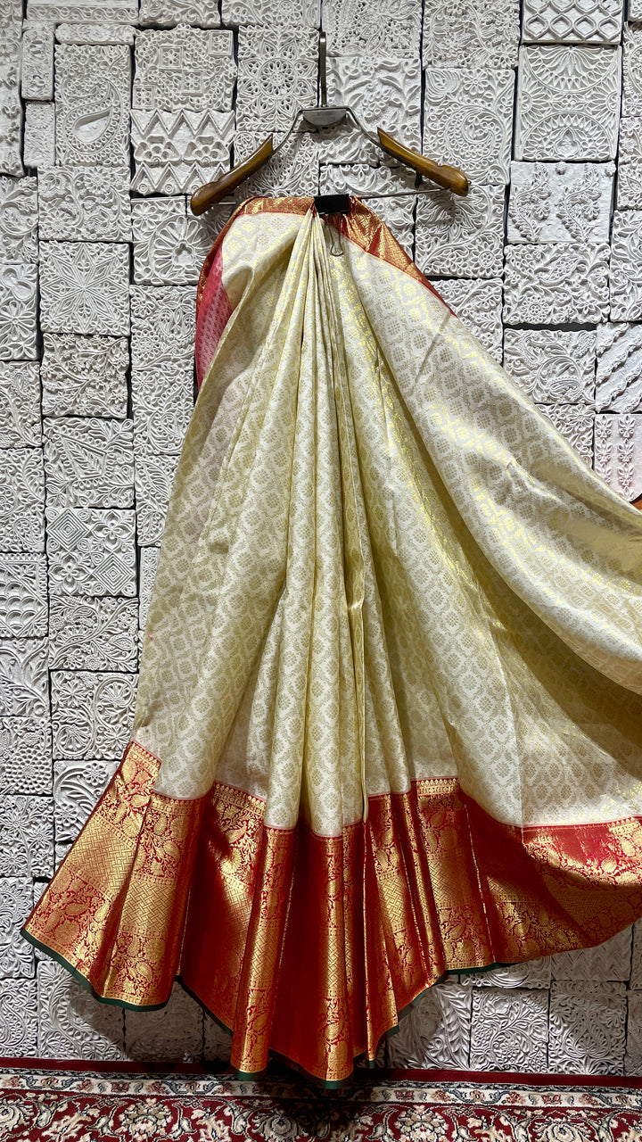 Cream silk kanjivaram saree with red border