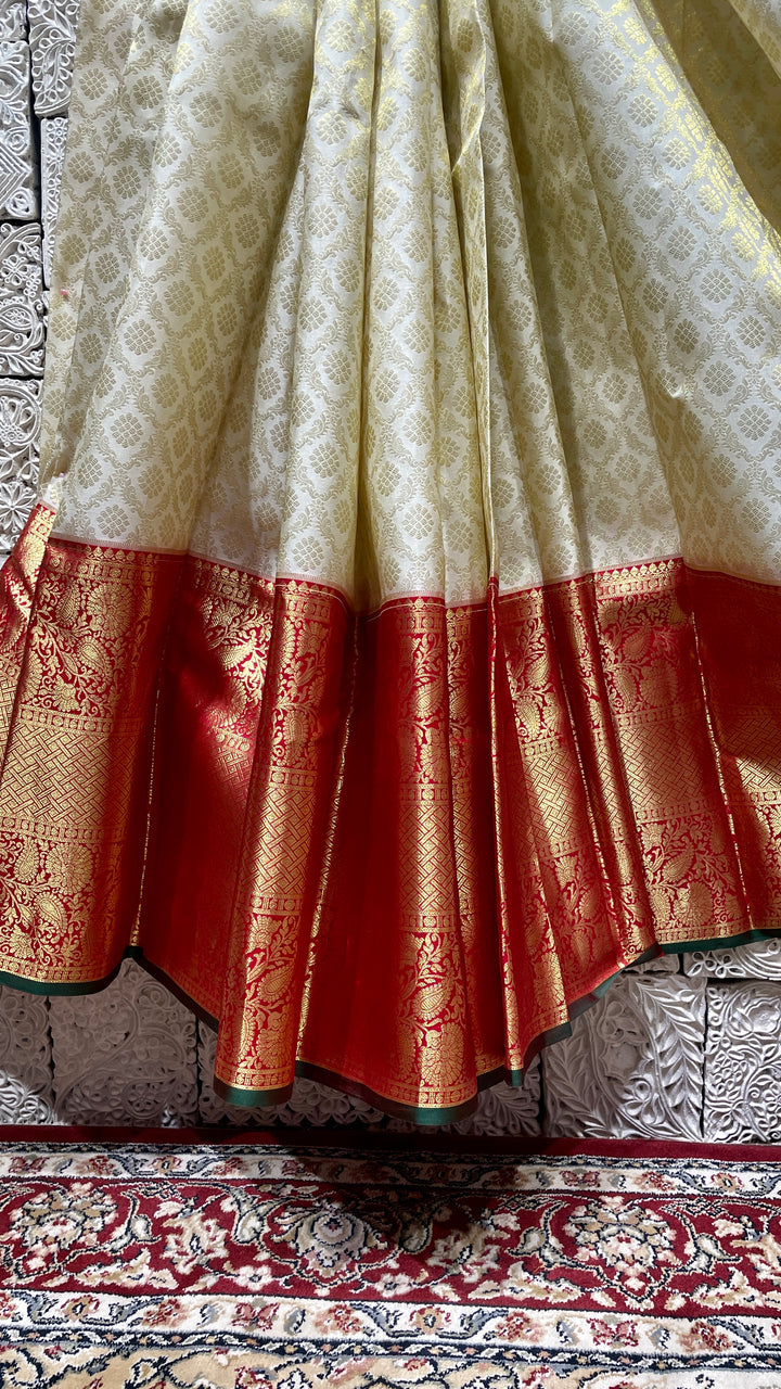 Cream silk kanjivaram saree with red border