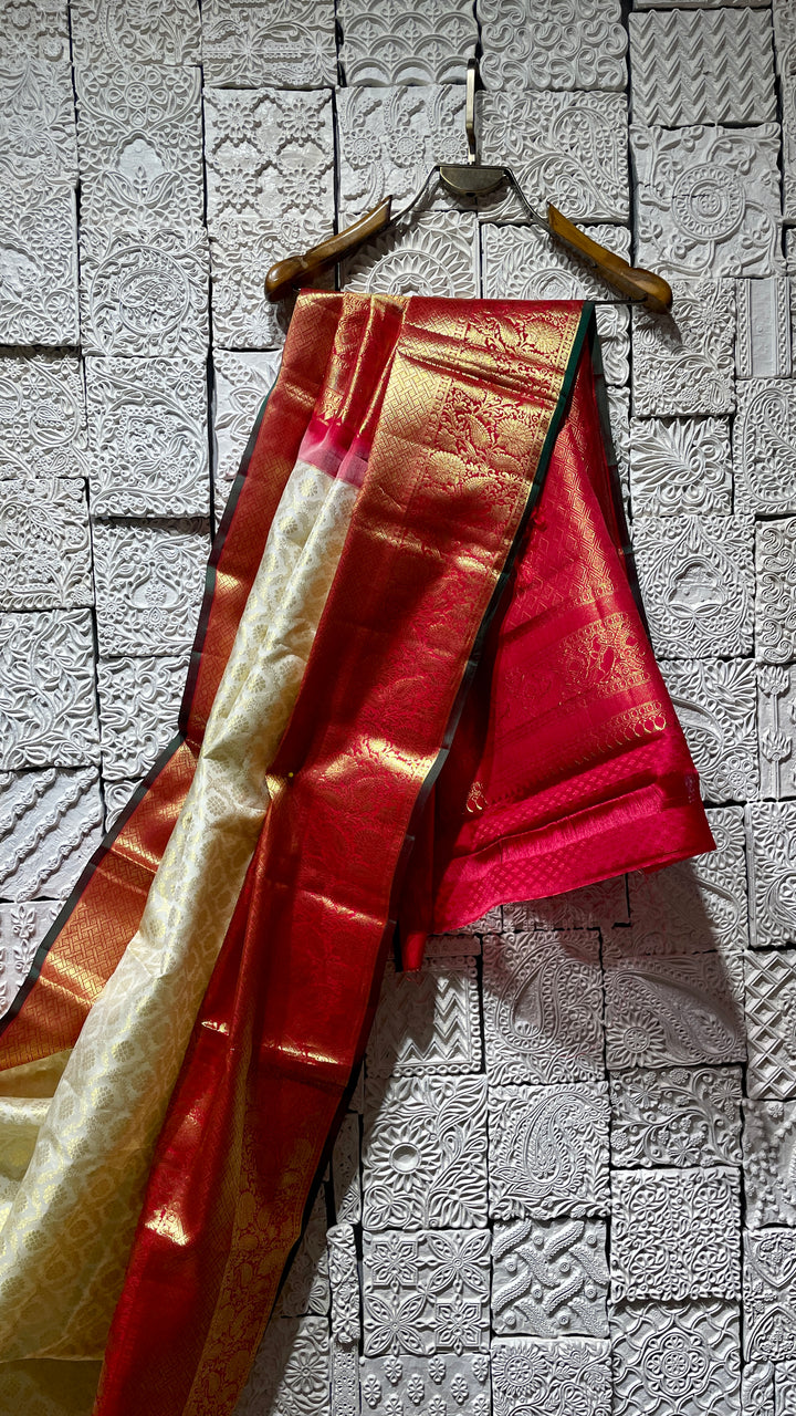 Cream silk kanjivaram saree with red border