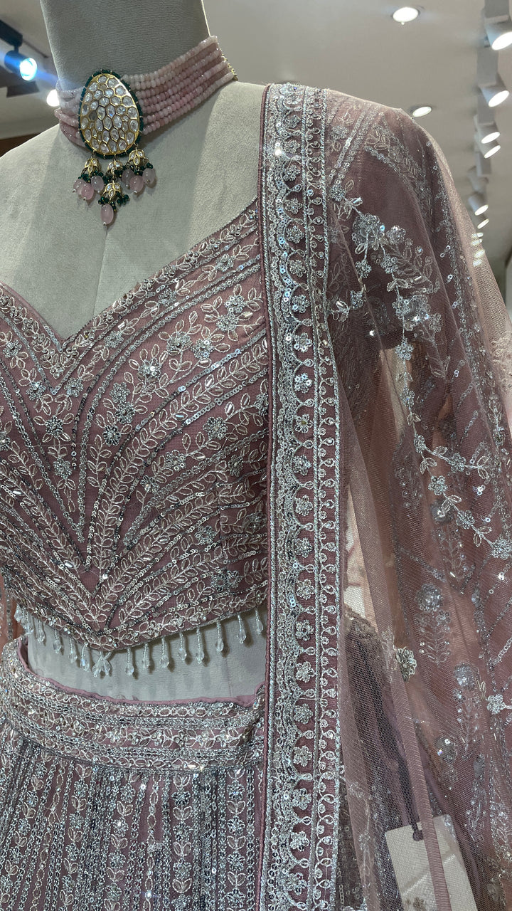 Peach net lehenga with sequins embellishments