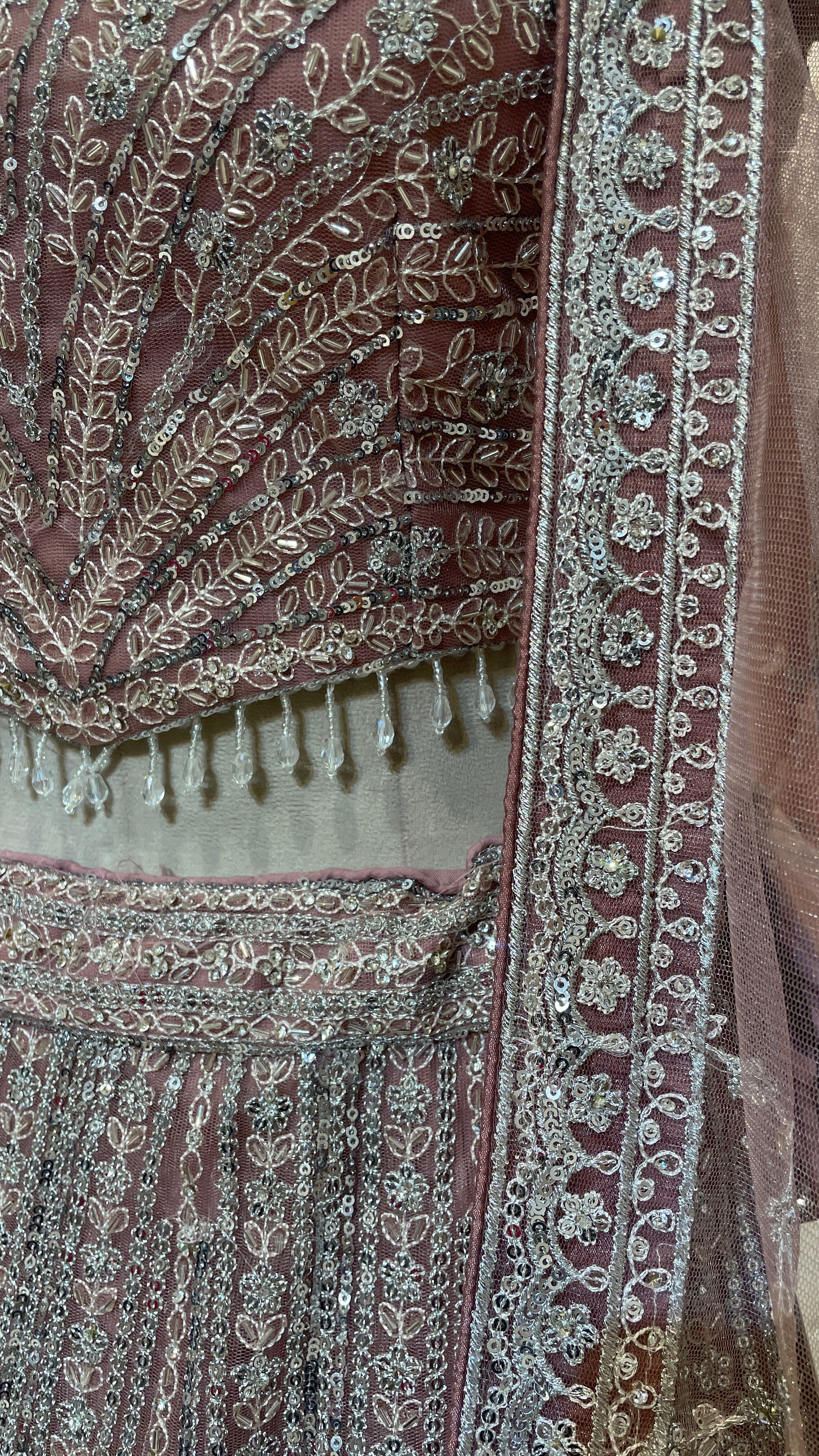 Peach net lehenga with sequins embellishments