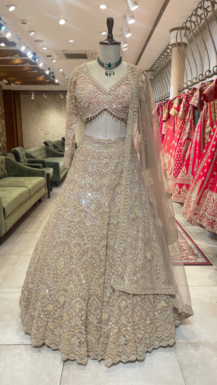 Peach net lehenga with sequins & bead embellishments