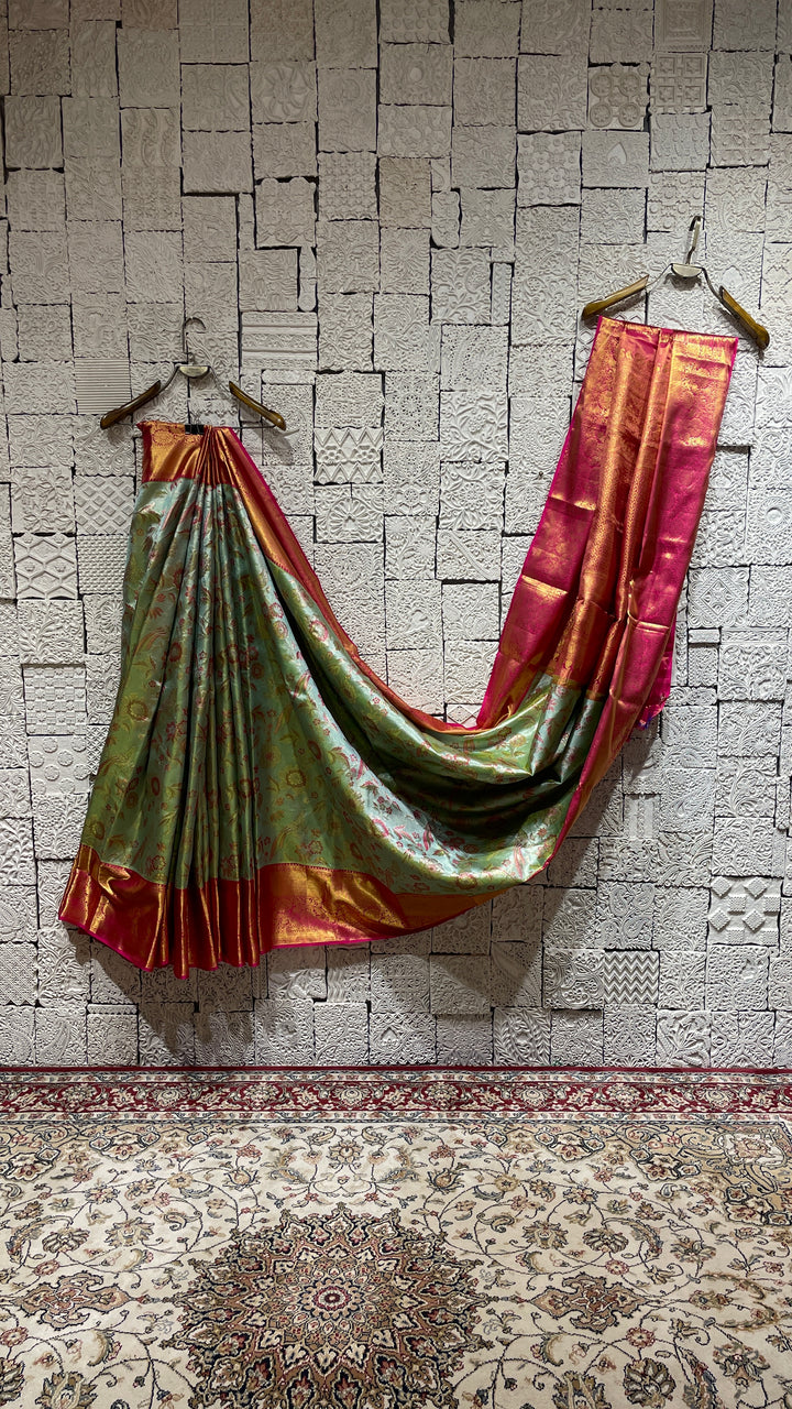 Green silk Kanjivaram saree with pink border