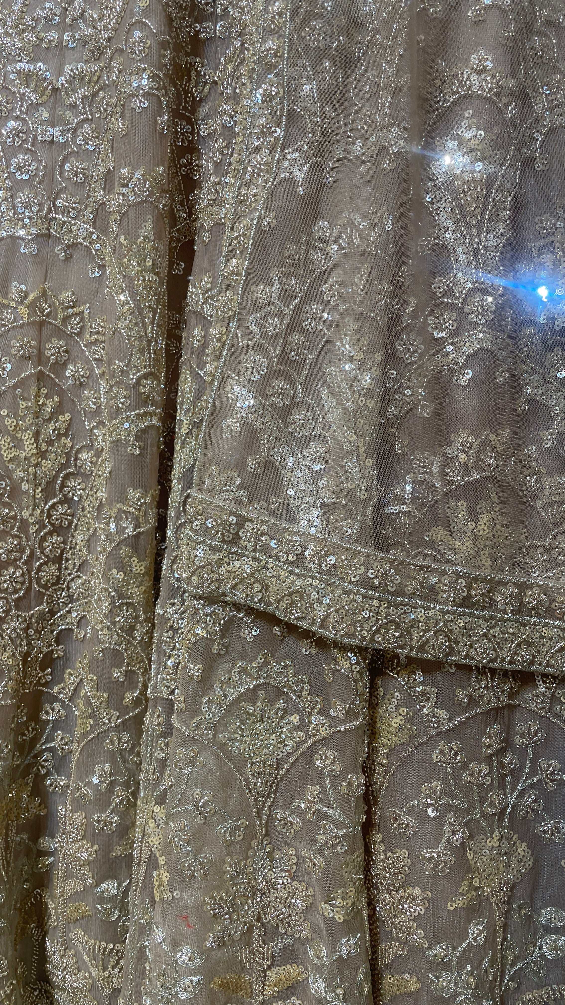 Peach net lehenga with sequins & bead embellishments