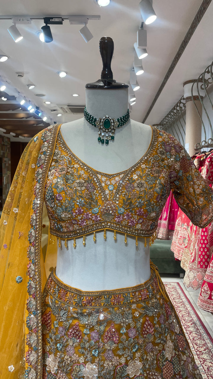 Mustard organza lehenga with floral motifs