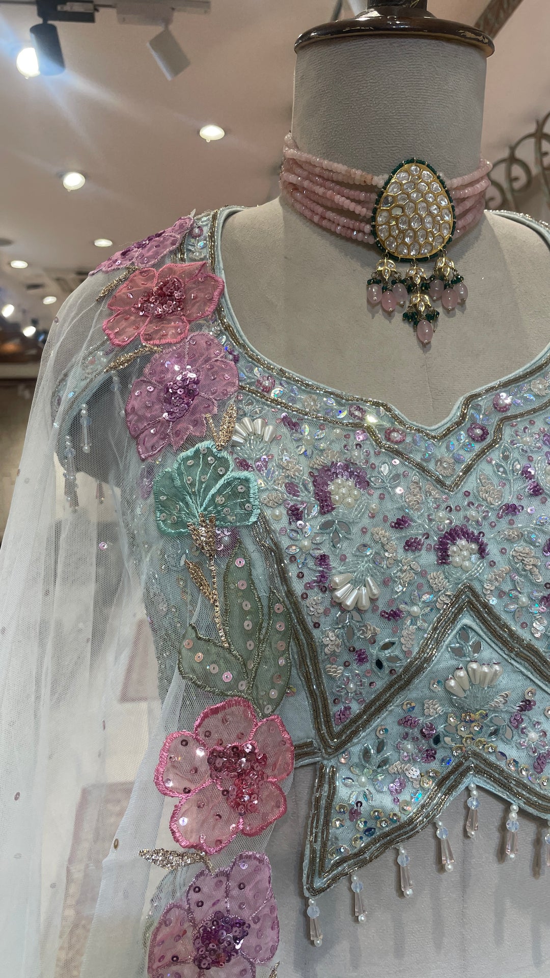 Pastel blue net lehenga with floral motifs