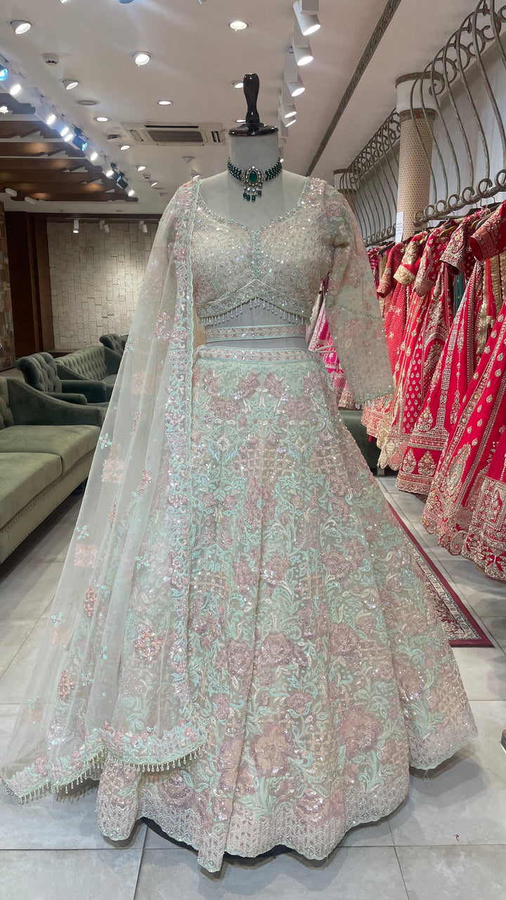 Ivory net lehenga with bead and sequins embellishments