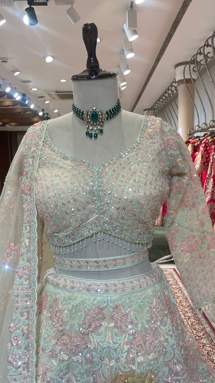 Ivory net lehenga with bead and sequins embellishments