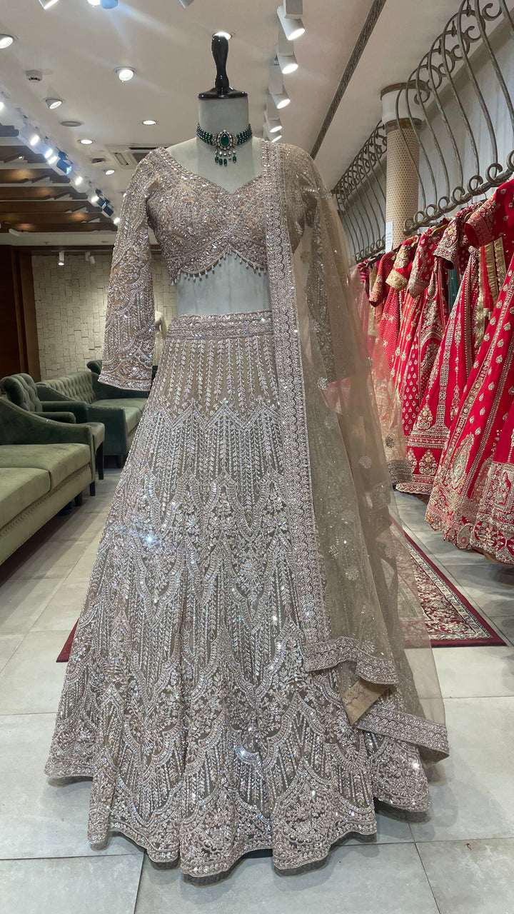 Peach net lehenga with mirrorwork & sequins