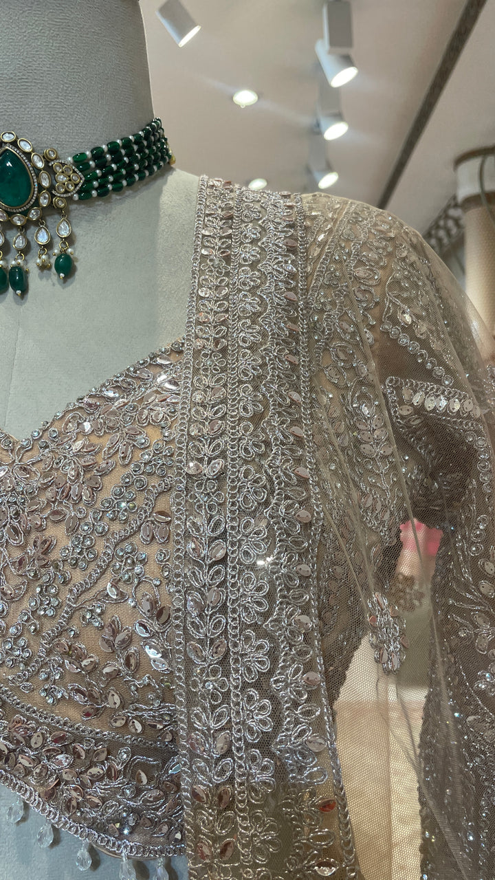 Peach net lehenga with mirrorwork & sequins