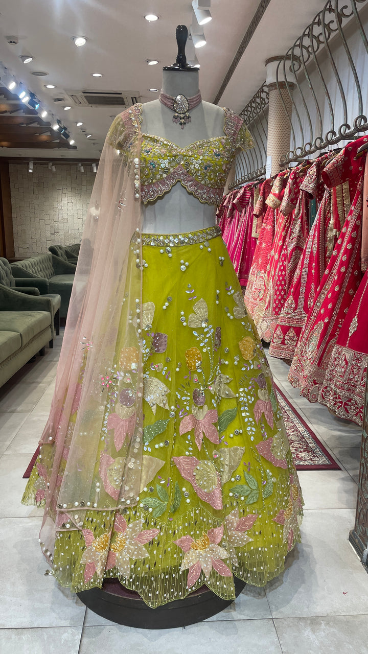 Green net lehenga with pearl embellishments & contrasting dupatta