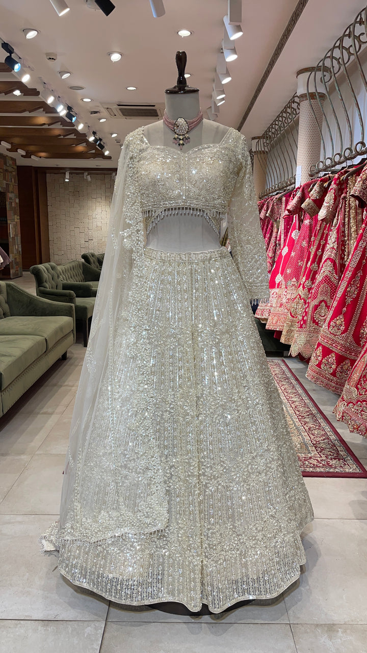 Ivory net lehenga with pearl and sequins embellishments