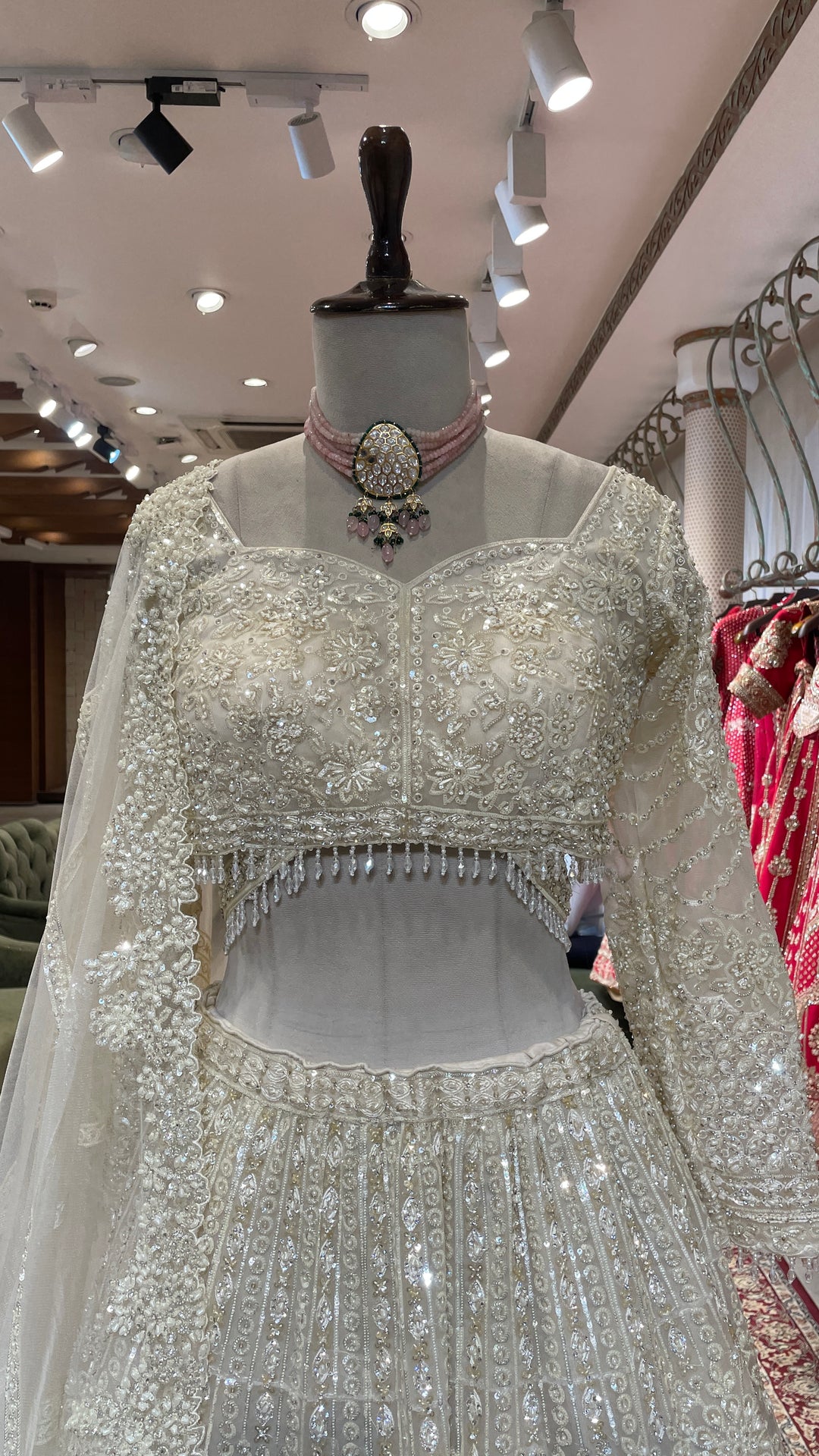 Ivory net lehenga with pearl and sequins embellishments