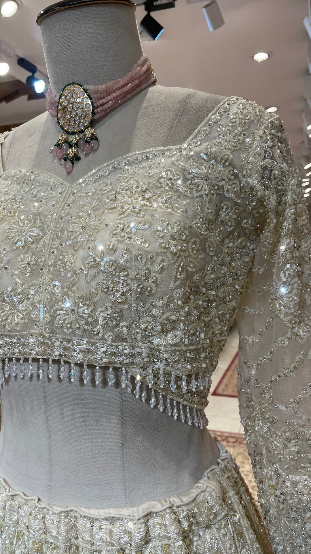 Ivory net lehenga with pearl and sequins embellishments