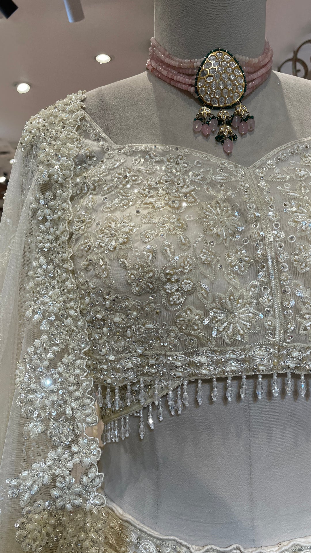 Ivory net lehenga with pearl and sequins embellishments