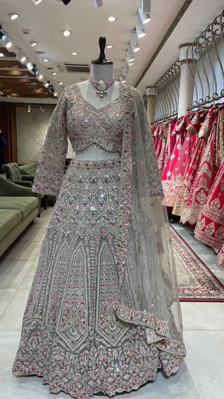 Peach net lehenga with multicolour threadwork and embellishments