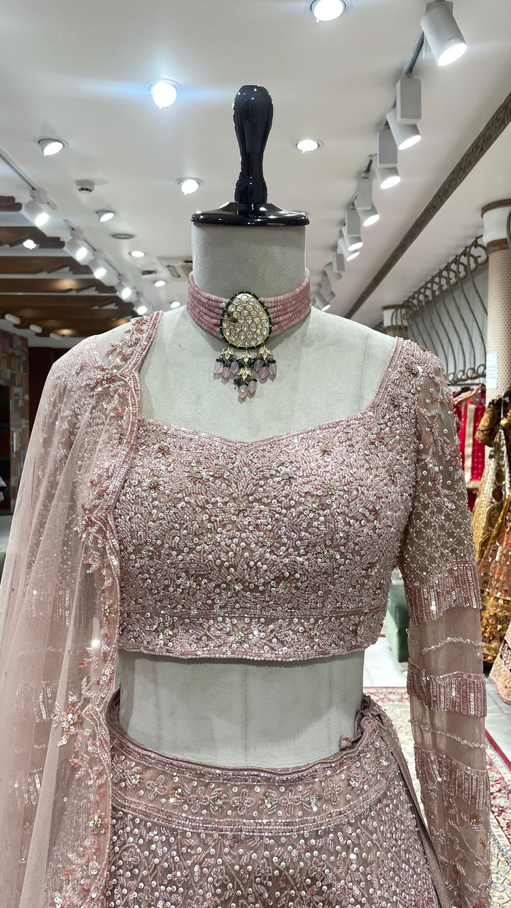 Pastel pink net lehenga with sequins pot and cutdana embroidery