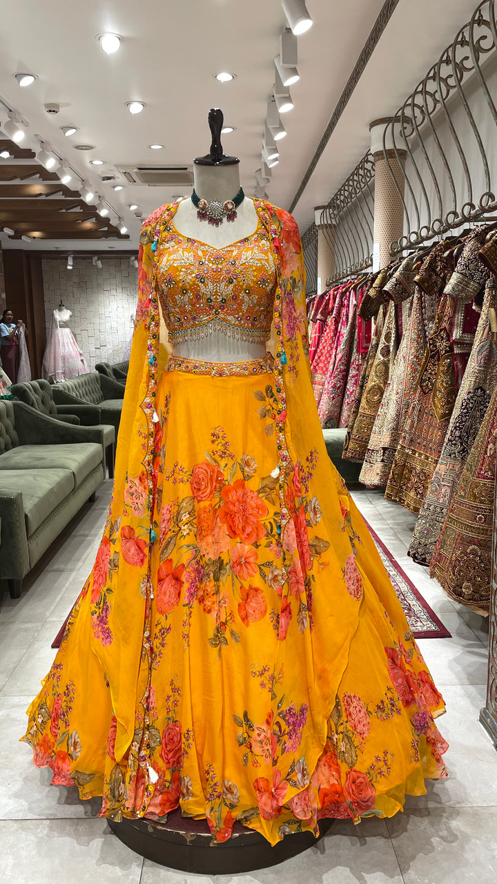 Yellow cape style organza lehenga with floral motifs