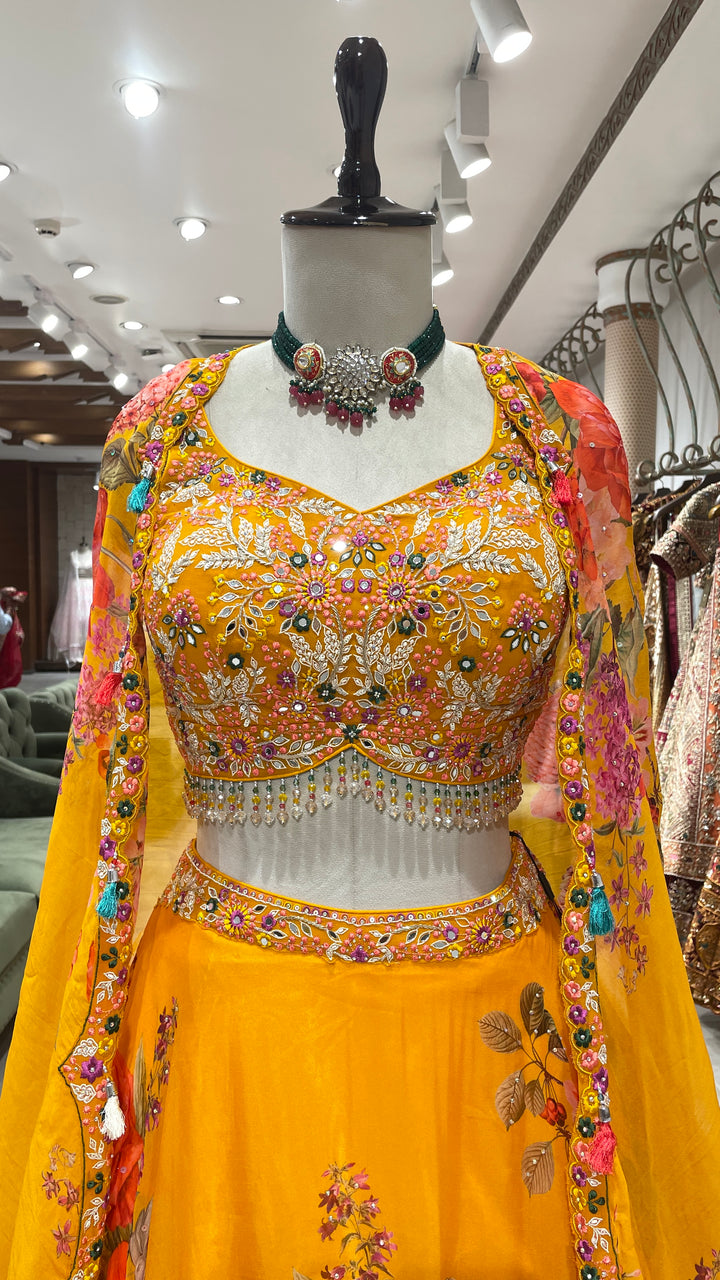 Yellow cape style organza lehenga with floral motifs