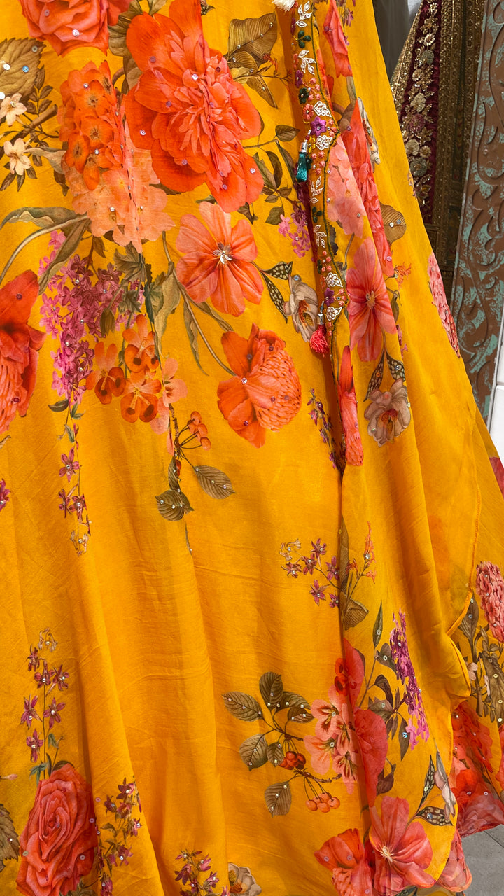 Yellow cape style organza lehenga with floral motifs