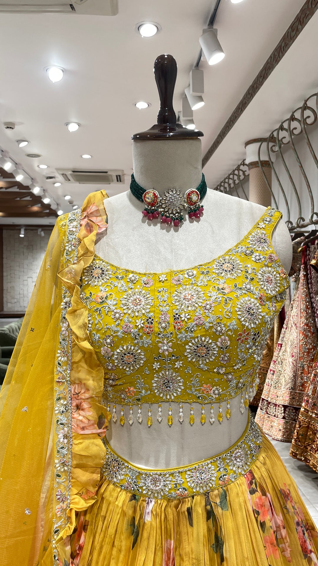 Yellow organza lehenga with floral motifs