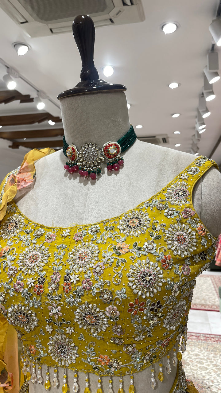 Yellow organza lehenga with floral motifs