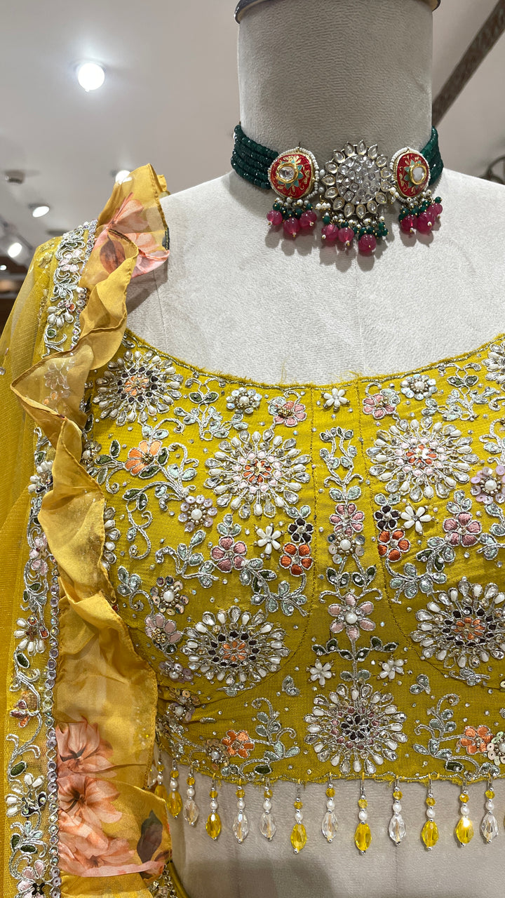 Yellow organza lehenga with floral motifs