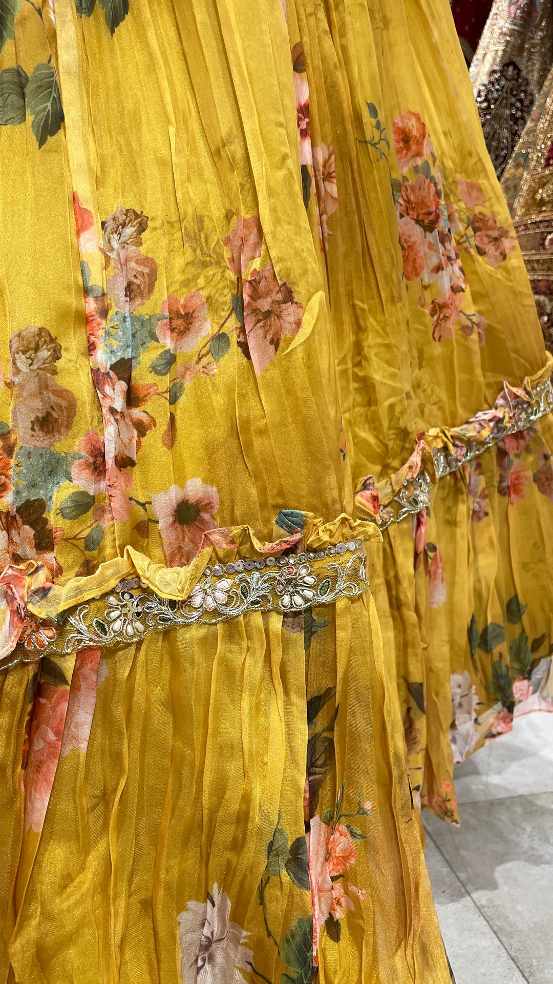 Yellow organza lehenga with floral motifs