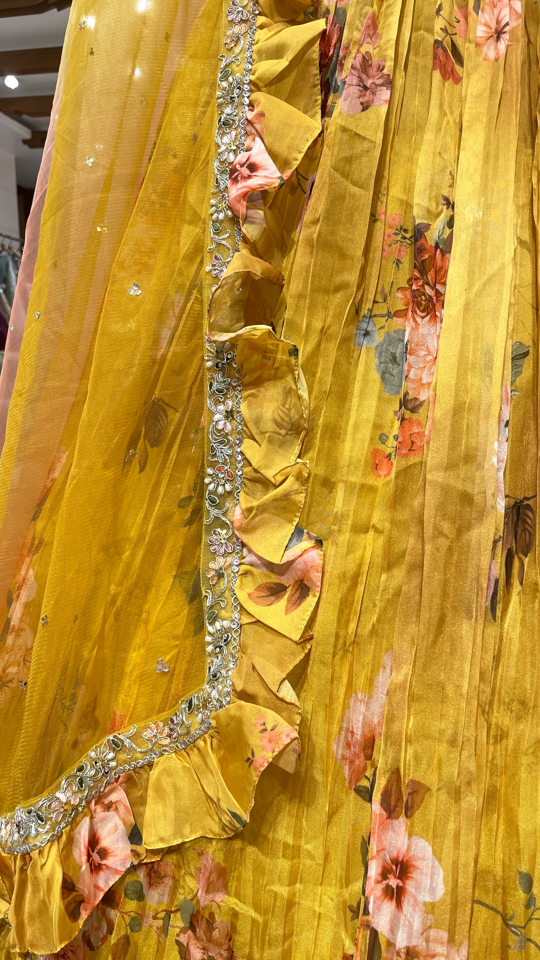 Yellow organza lehenga with floral motifs