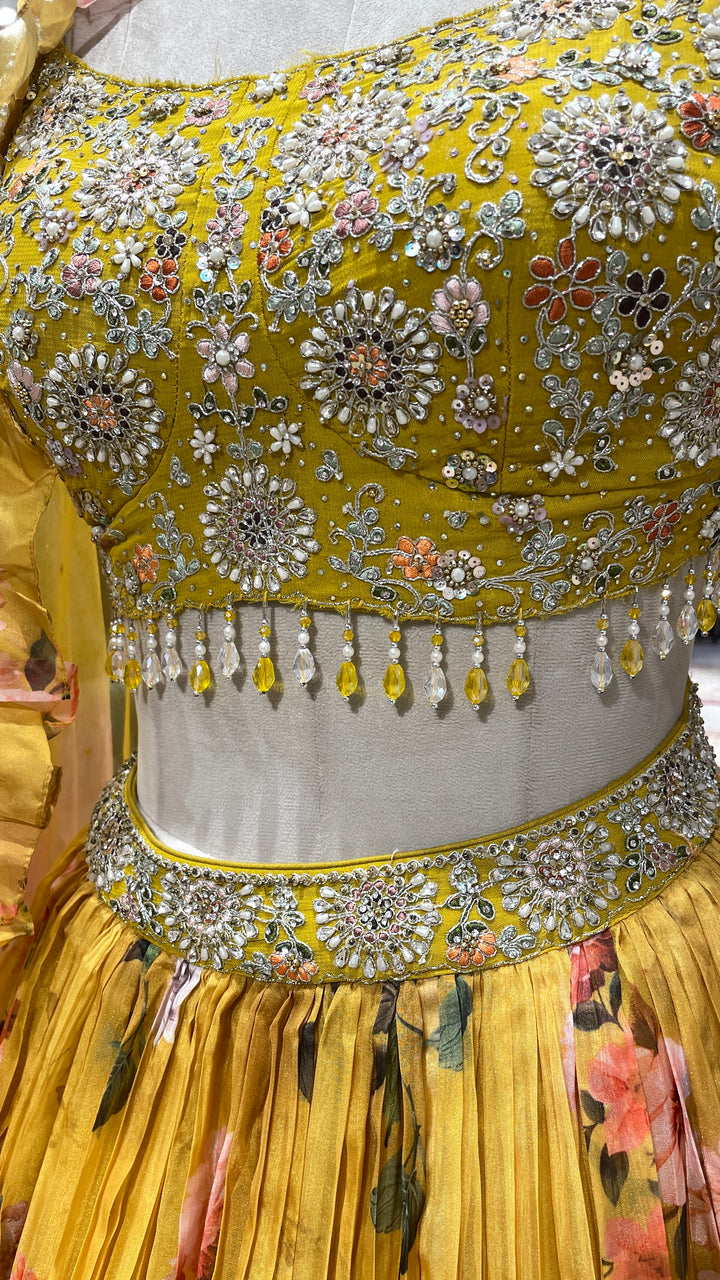 Yellow organza lehenga with floral motifs