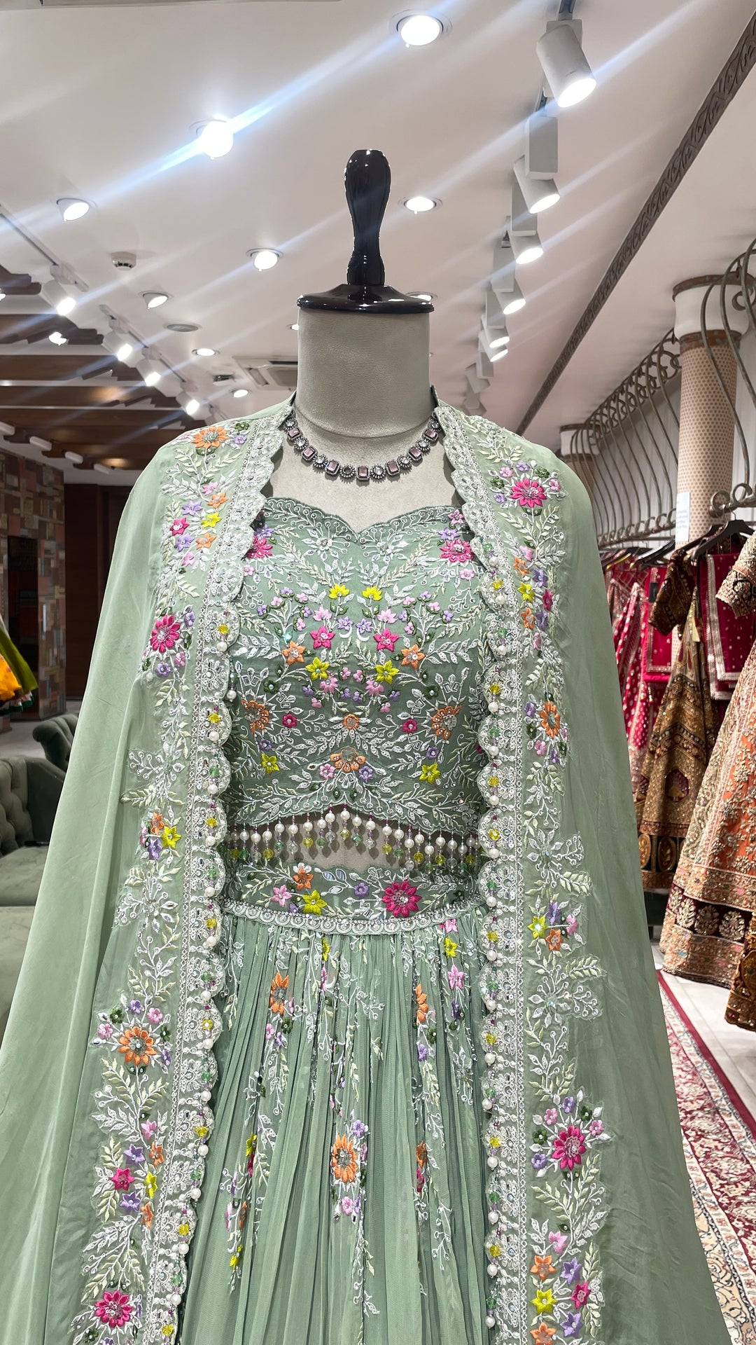 Pastel green Georgette lehenga  with cape and floral motifs