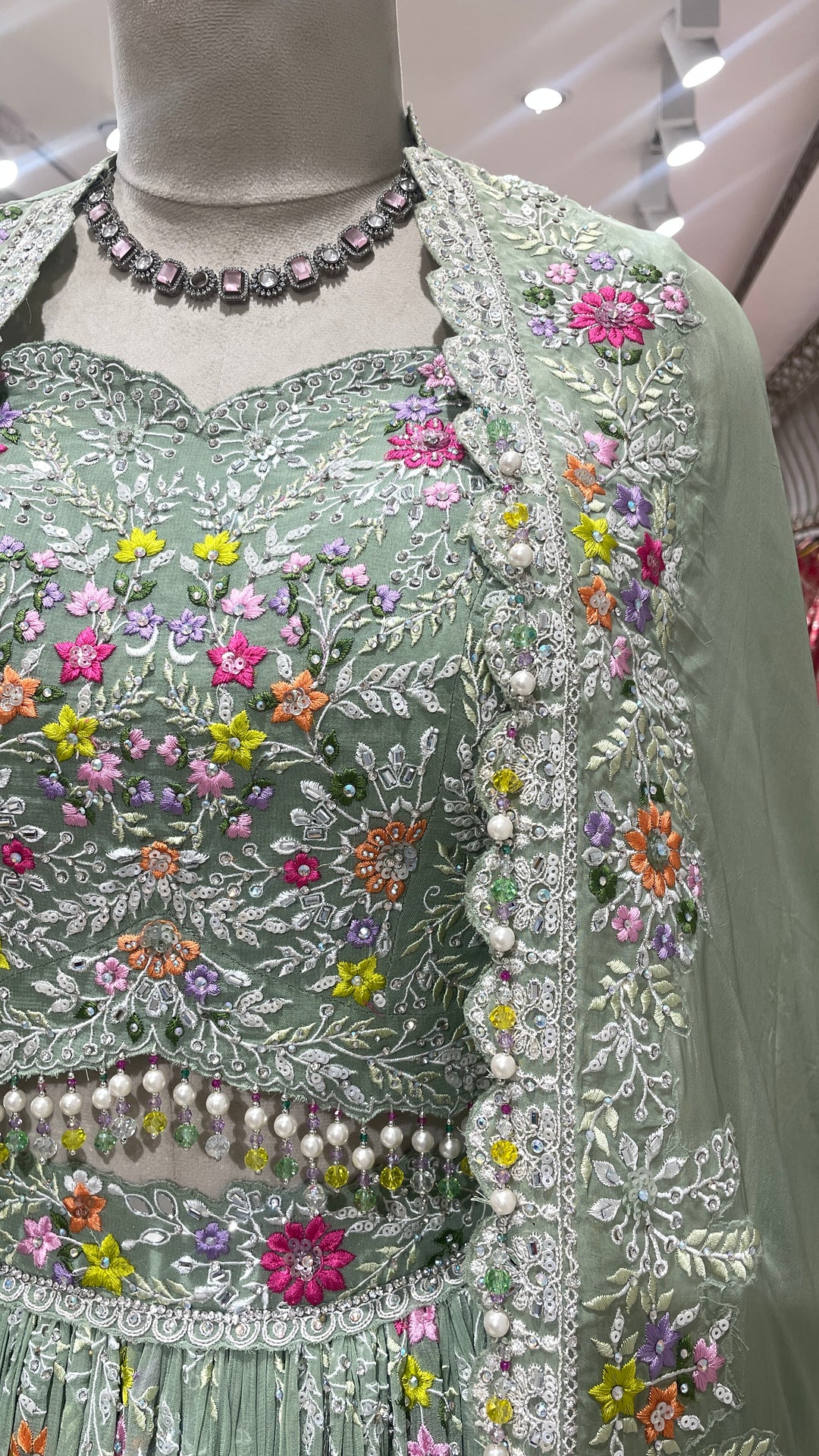 Pastel green Georgette lehenga  with cape and floral motifs