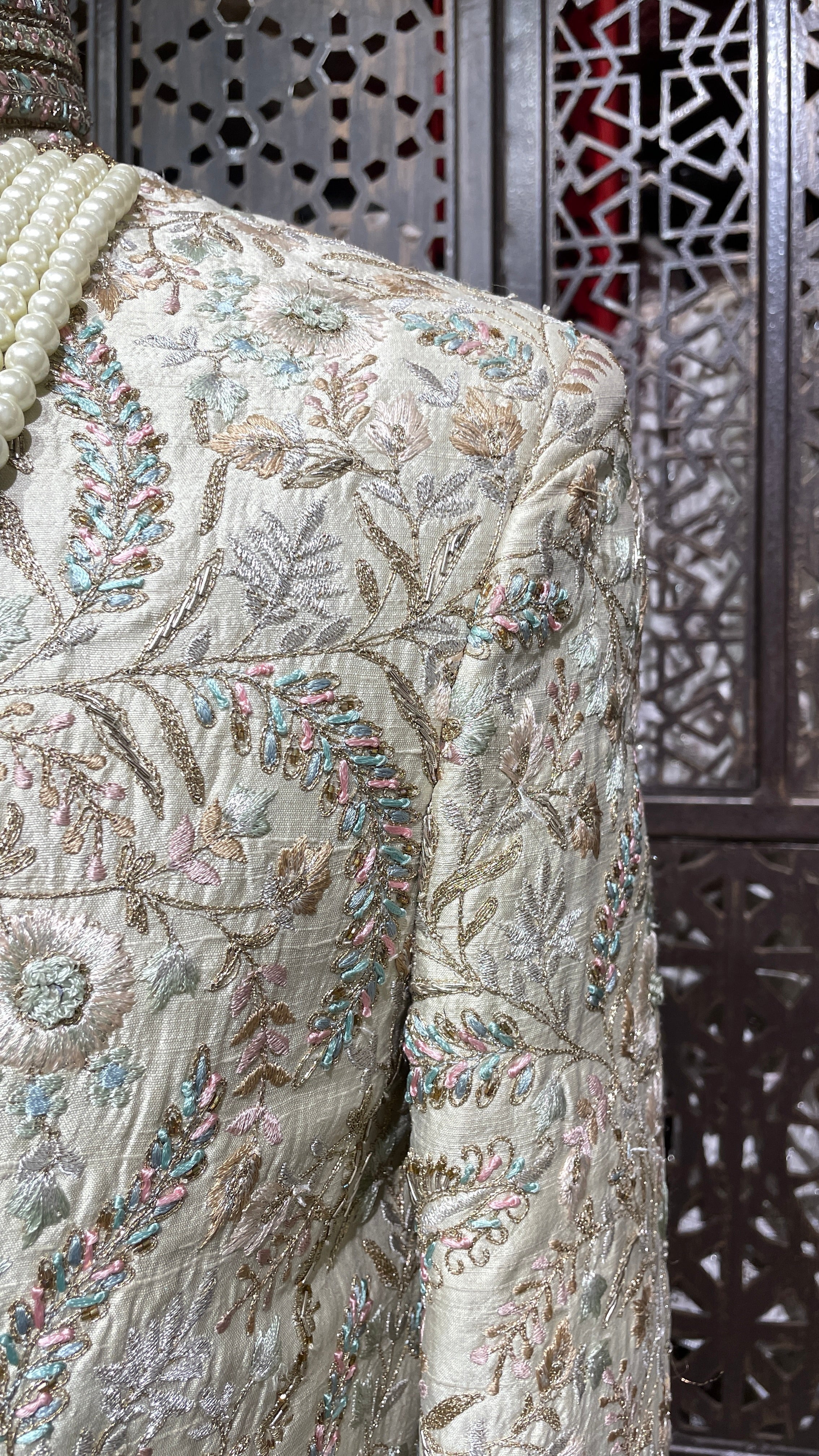 Cream men’s silk sherwani with floral motifs