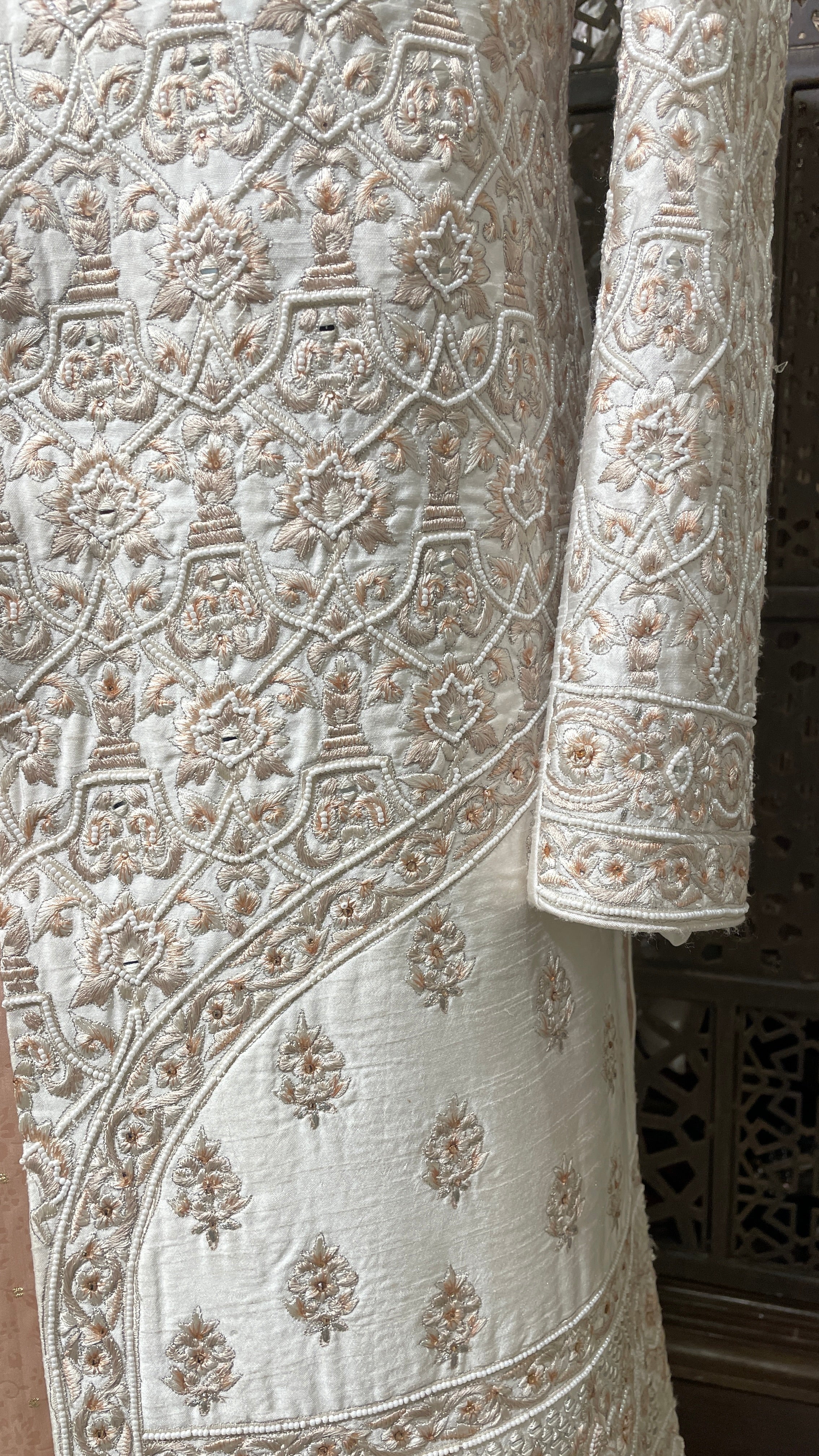 Cream men’s silk sherwani with floral motifs