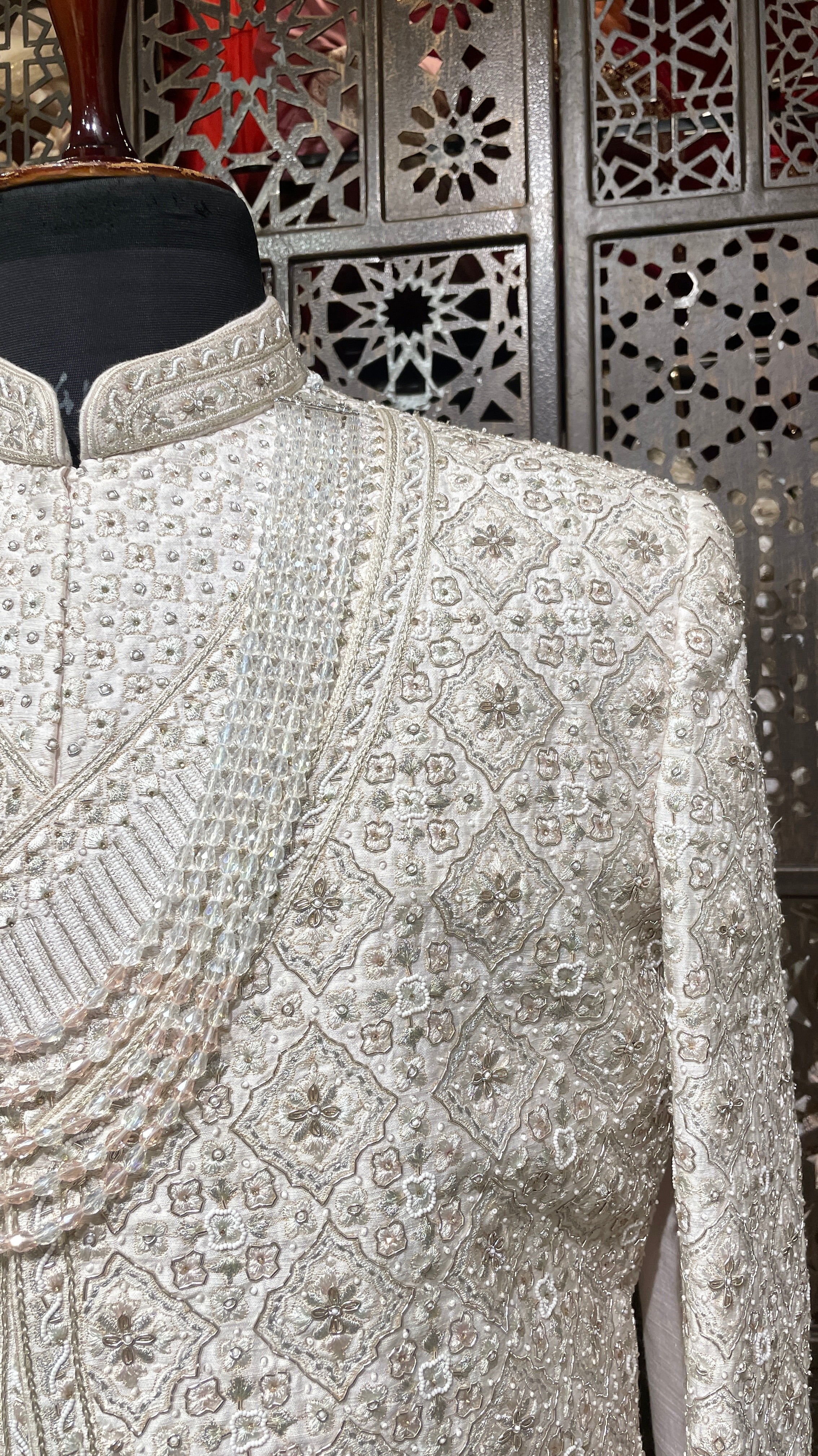 Cream layered sherwani with peacock motifs and zariwork