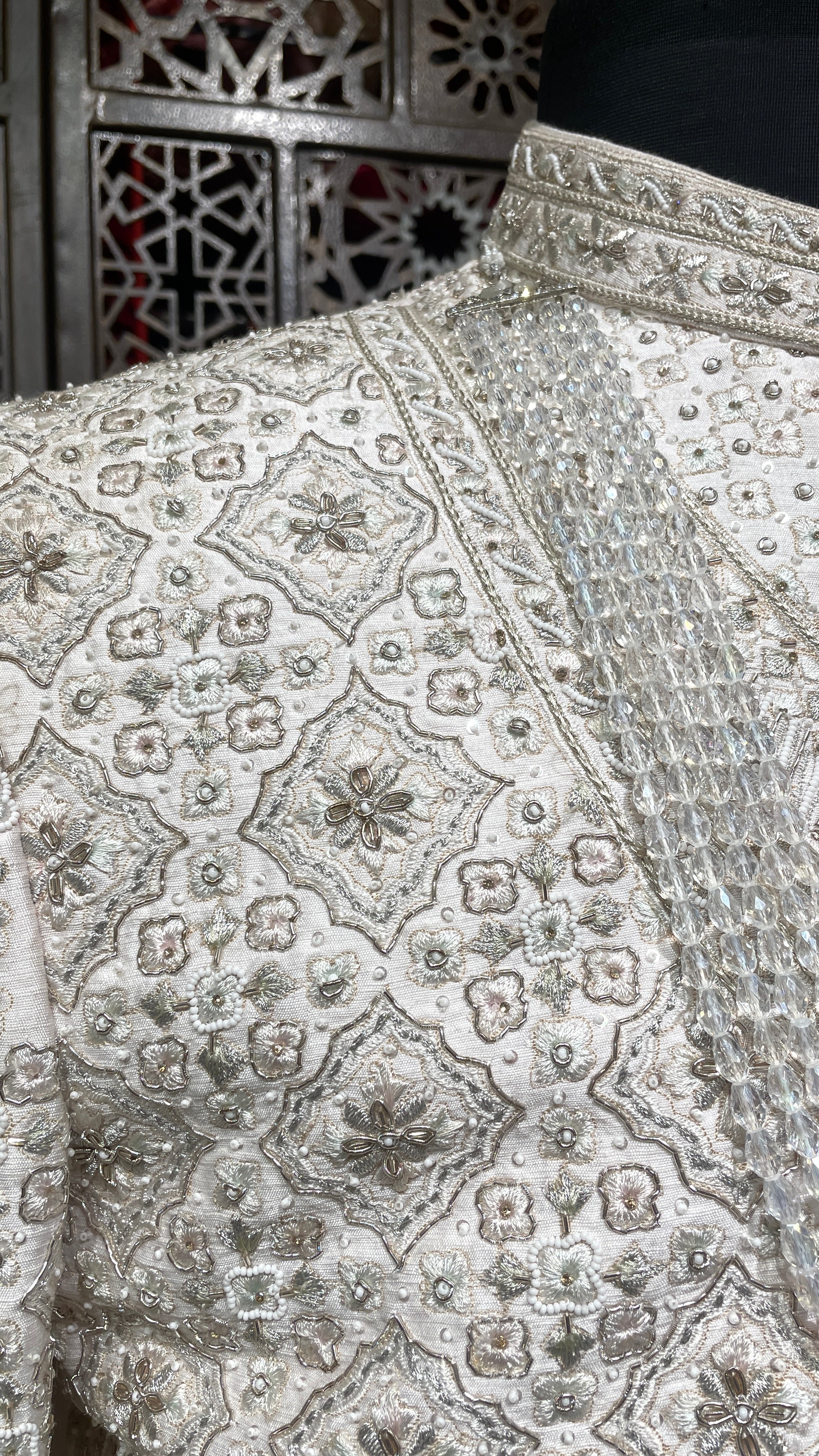 Cream layered sherwani with peacock motifs and zariwork