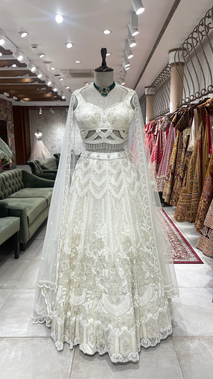 Ivory Net lehenga with sequins cutdana and pot embellishments