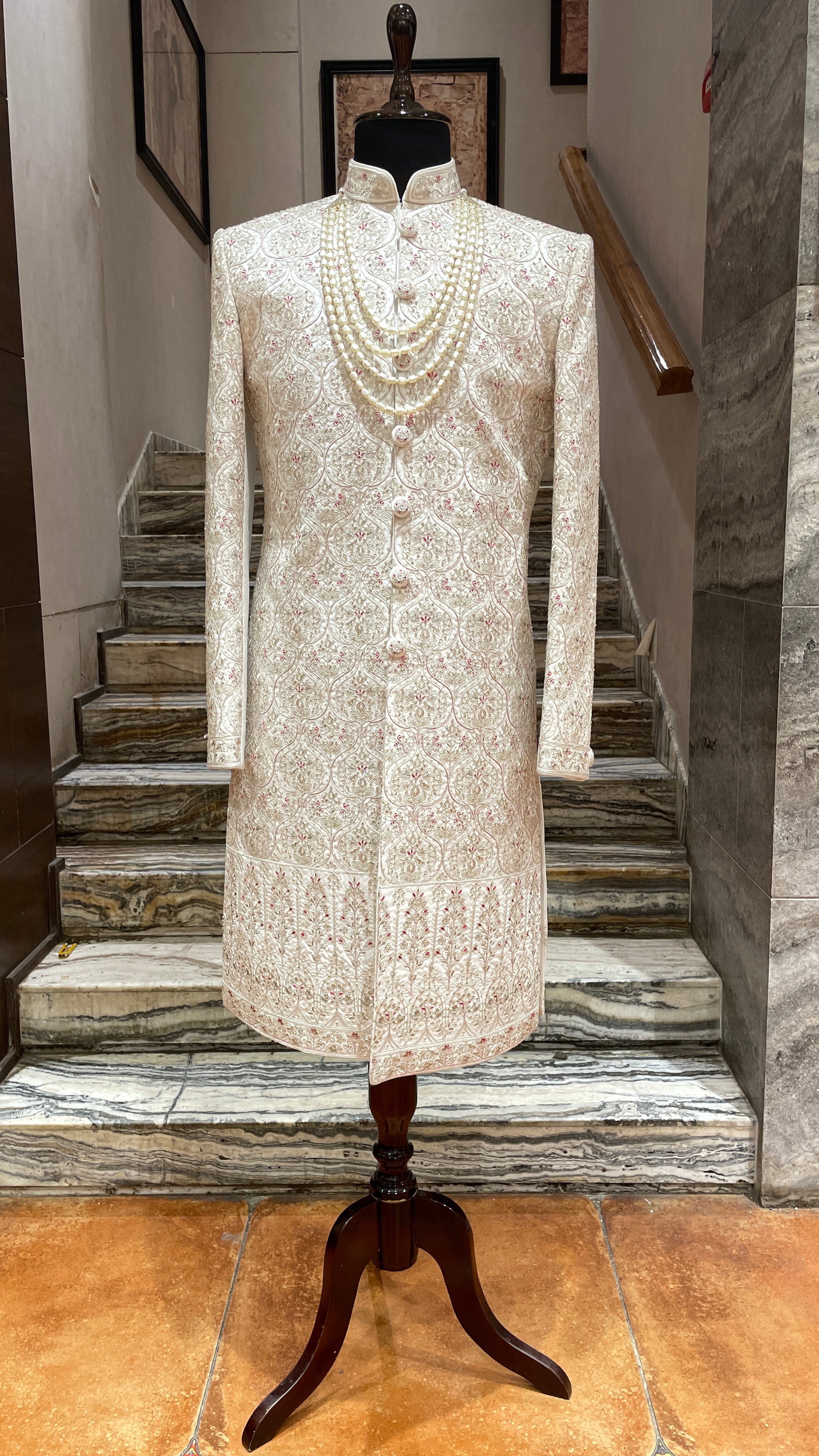 Cream silk sherwani with red motifs