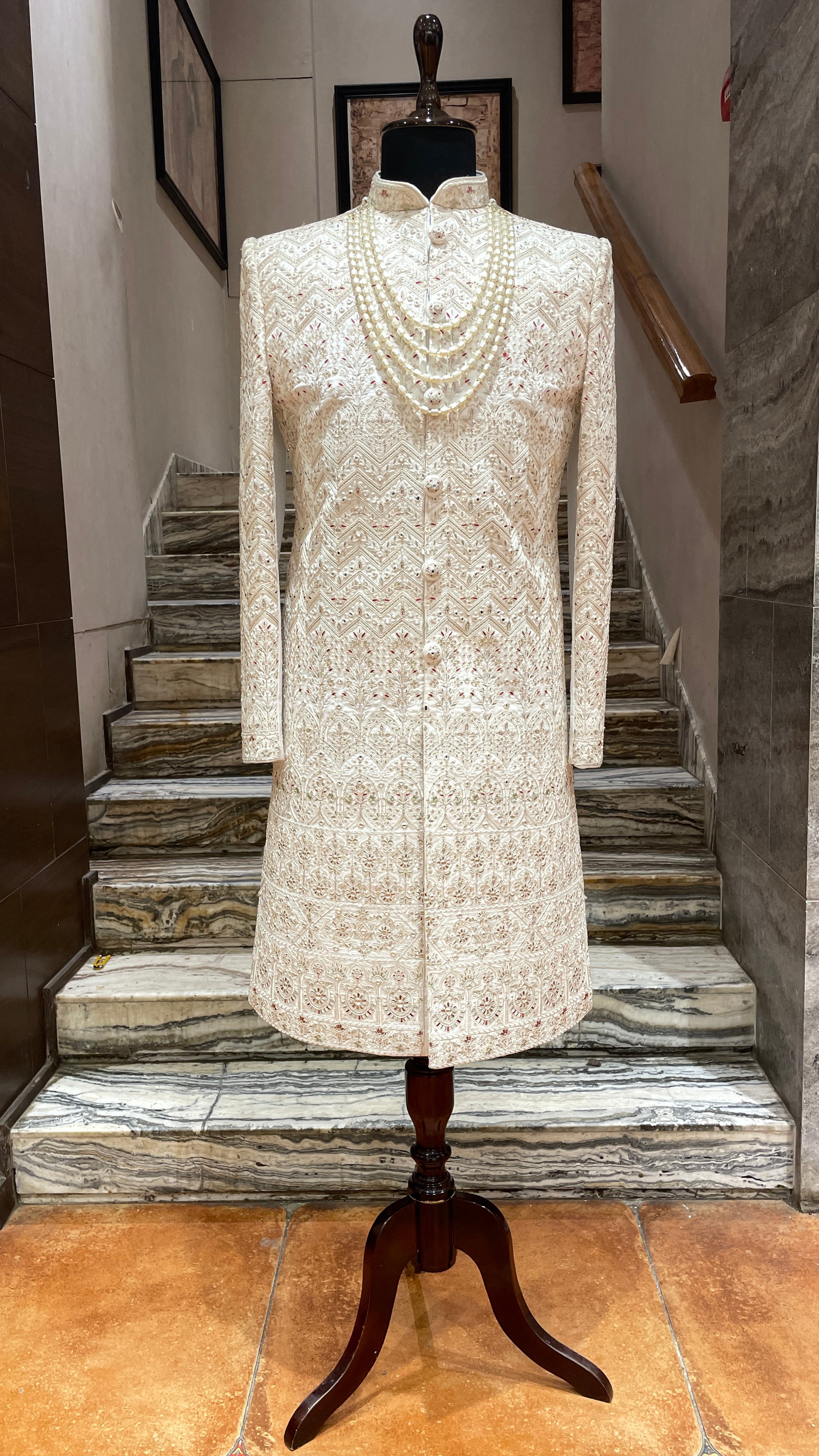 Cream silk sherwani with red and gold embroidery