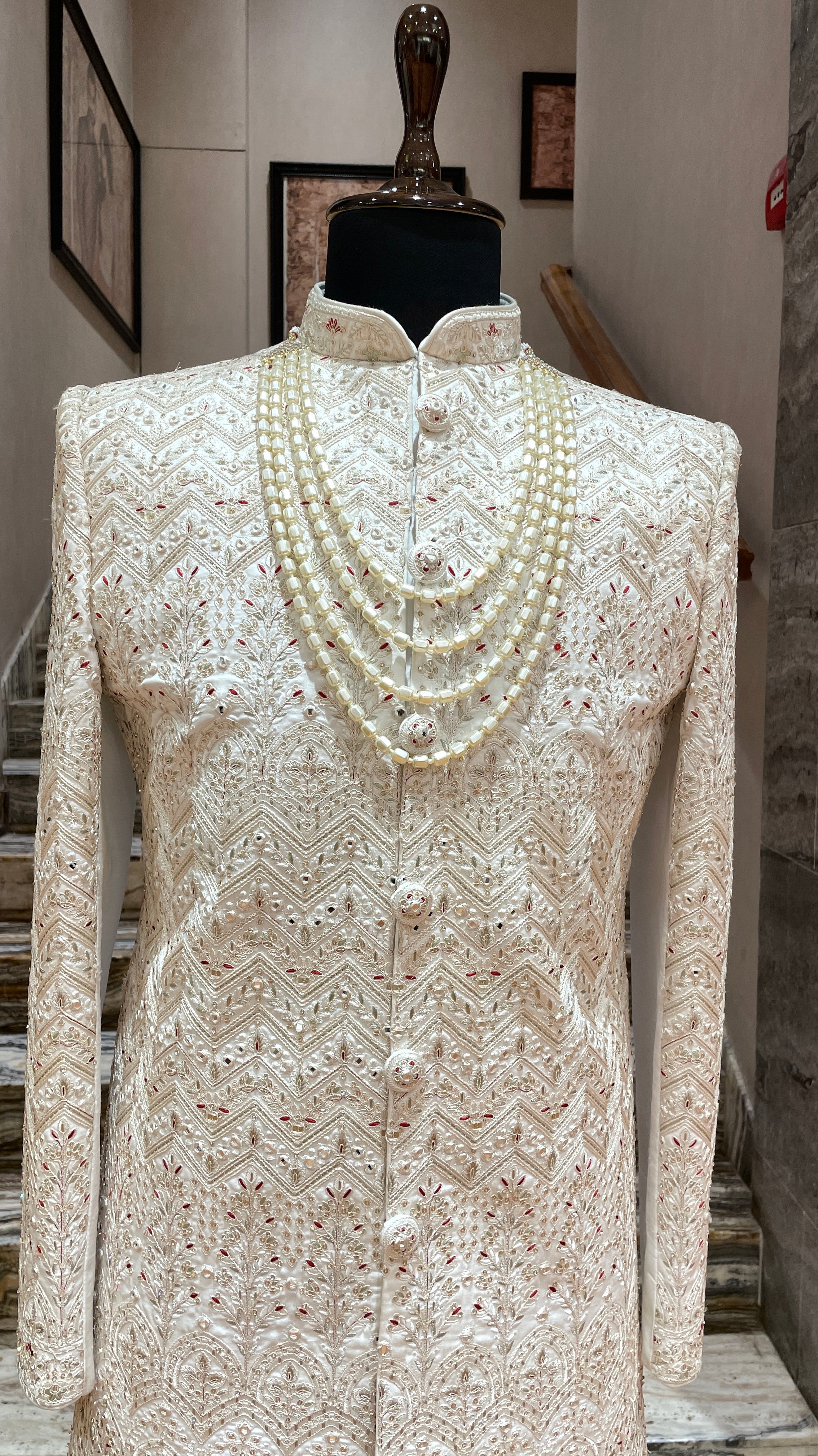 Cream silk sherwani with red and gold embroidery
