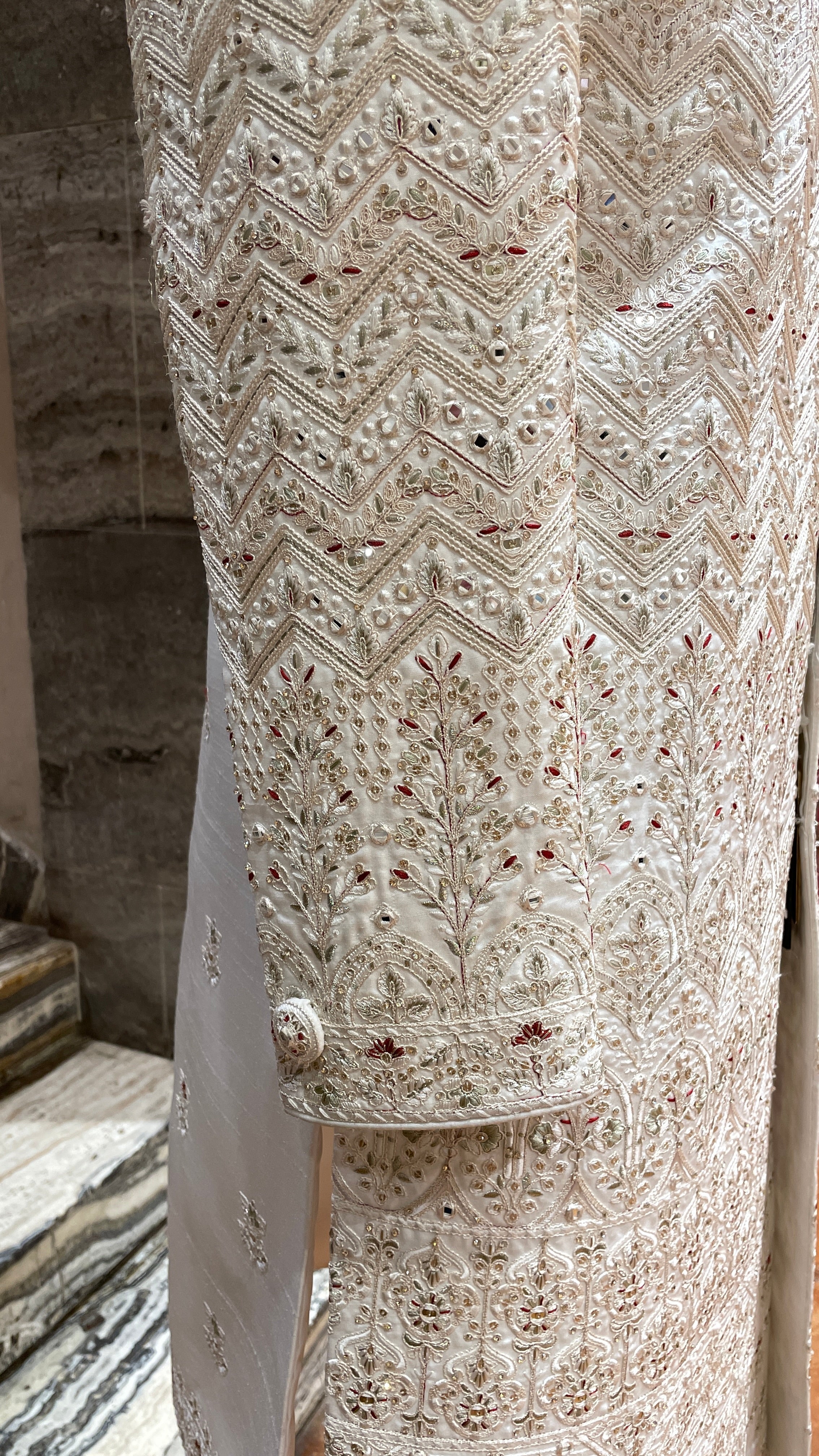 Cream silk sherwani with red and gold embroidery