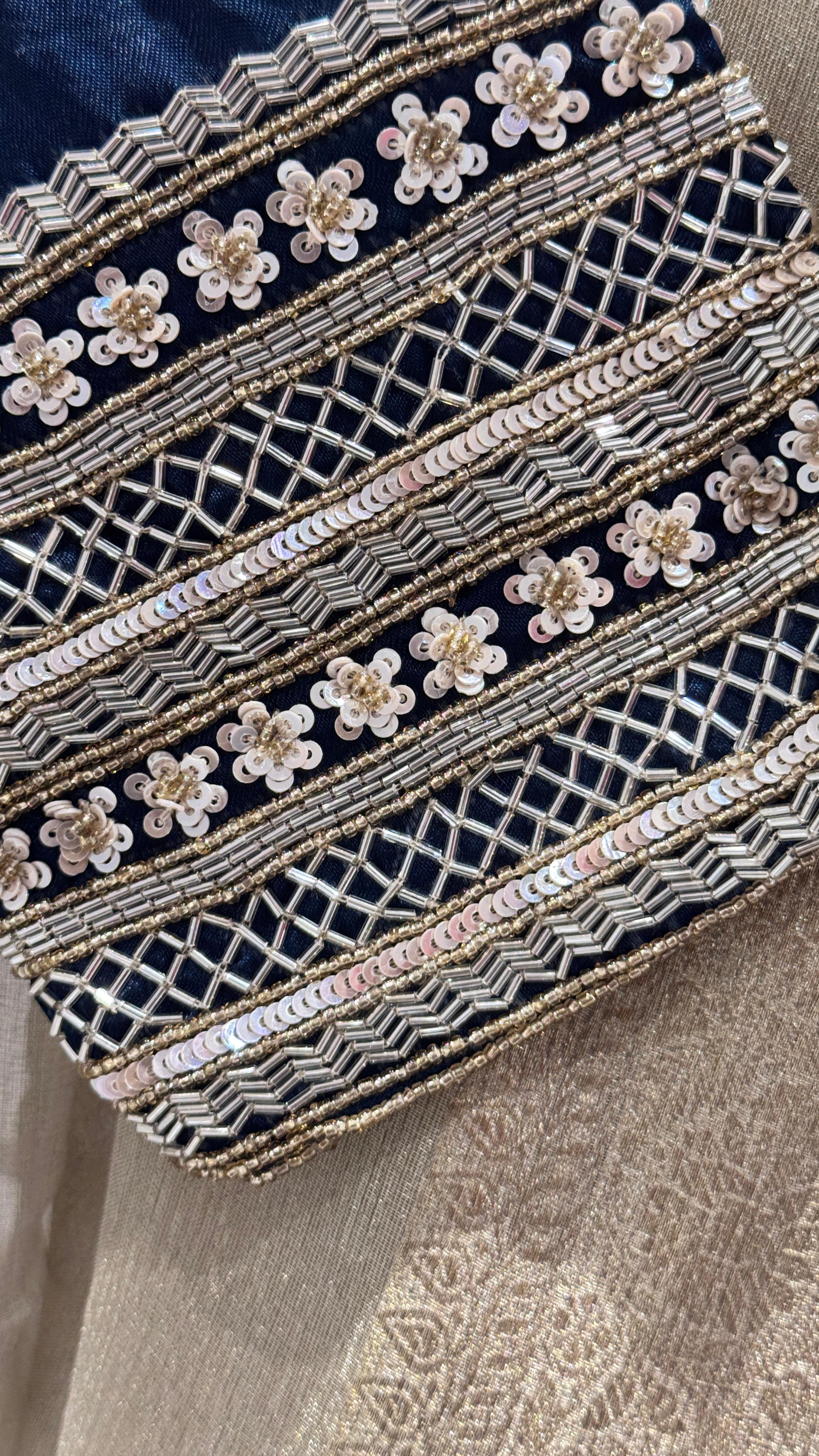 Gold color saree with zig-zag sequience border