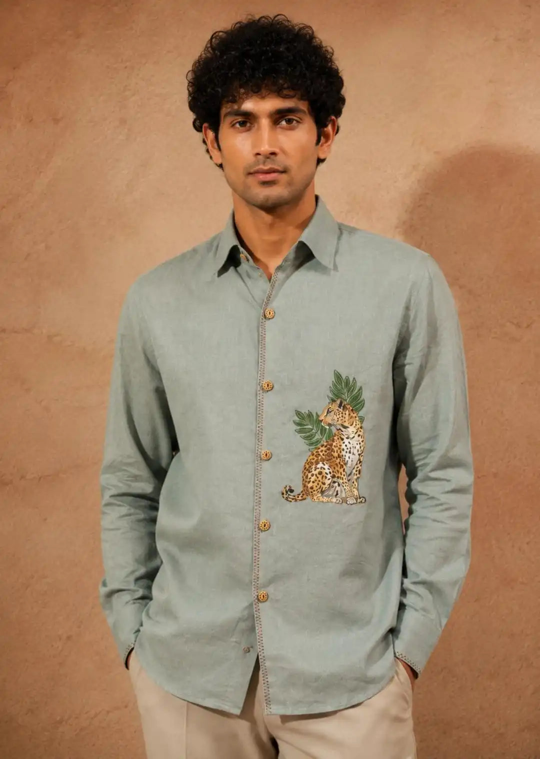 Sage green linen hand-painted shirt with signature leopard & tropical leaf artwork on chest