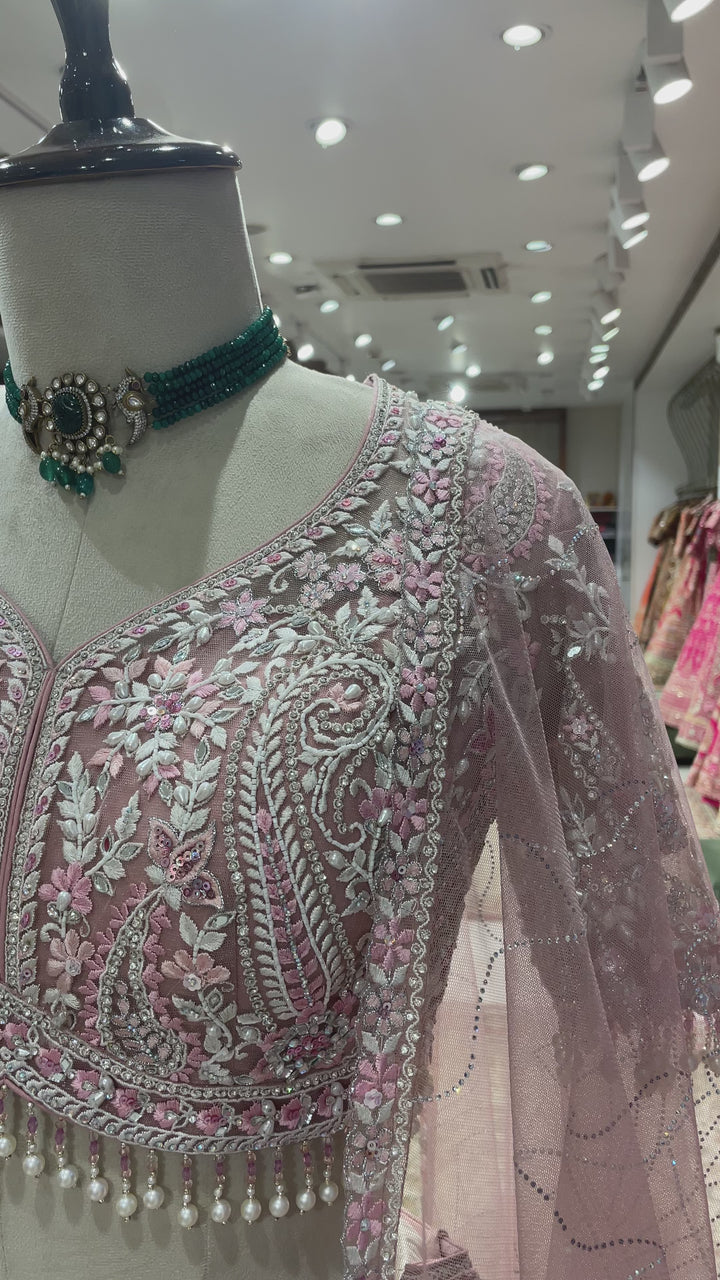 Pink net lehenga with mirrorwork and floral motifs