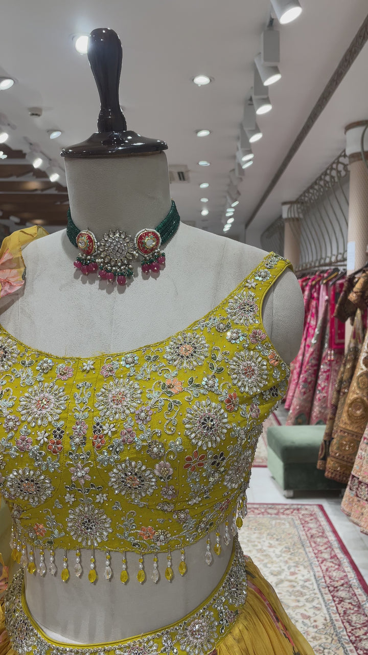 Yellow organza lehenga with floral motifs