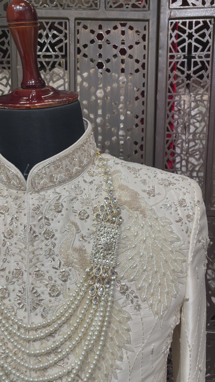 Ivory men’s silk sherwani with peacock motifs